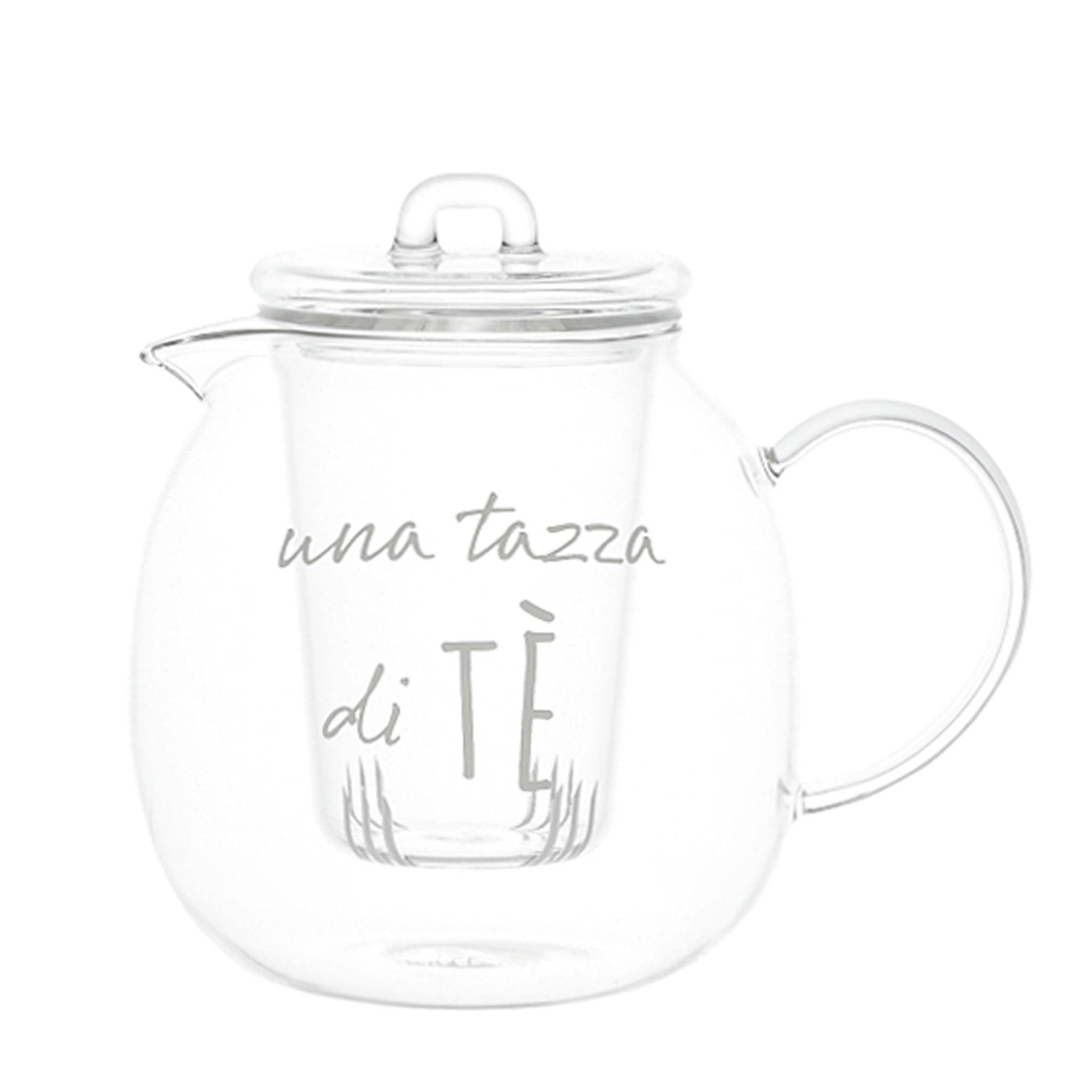 A small teapot a cup of tea